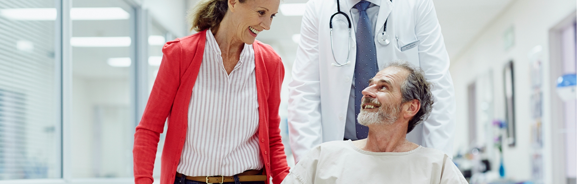 Patient in Wheelchair with Family Member and Doctor